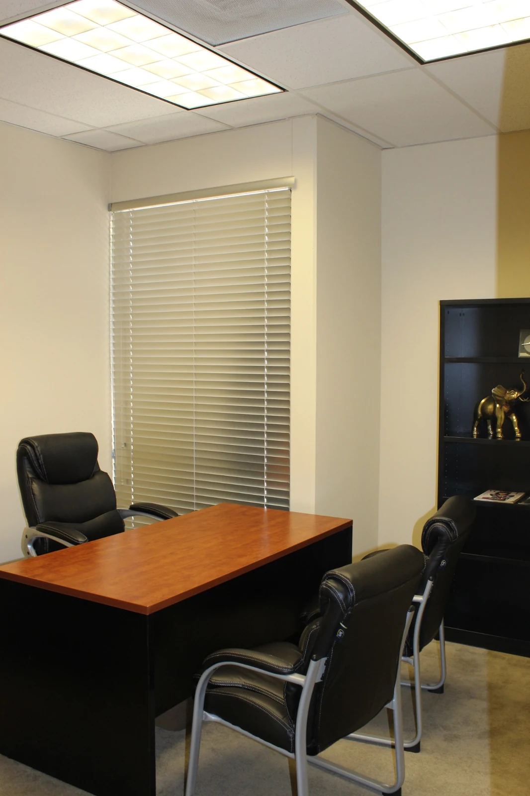 Furnished office with desk, window and two guest chairs at Gateway Executive Suites, 500 East E Street
