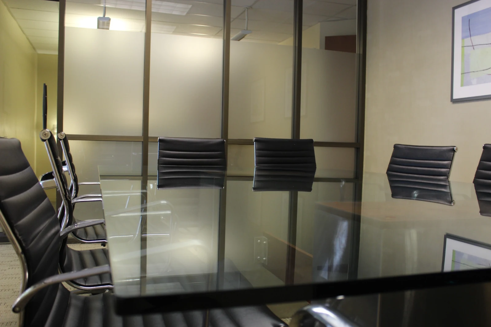Glass meeting table and ribbed chairs at Gateway Executive Suites