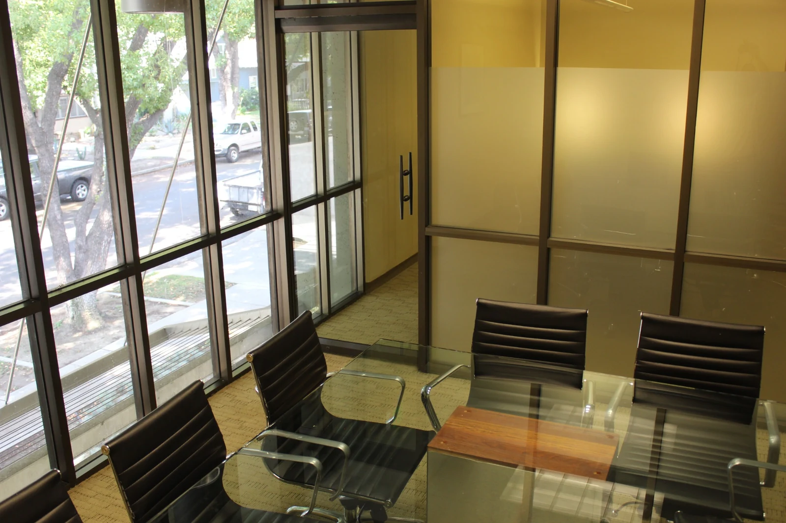 Gateway Executive Suites: meeting room with a glass table and windows overlooking trees at 500 East E Street