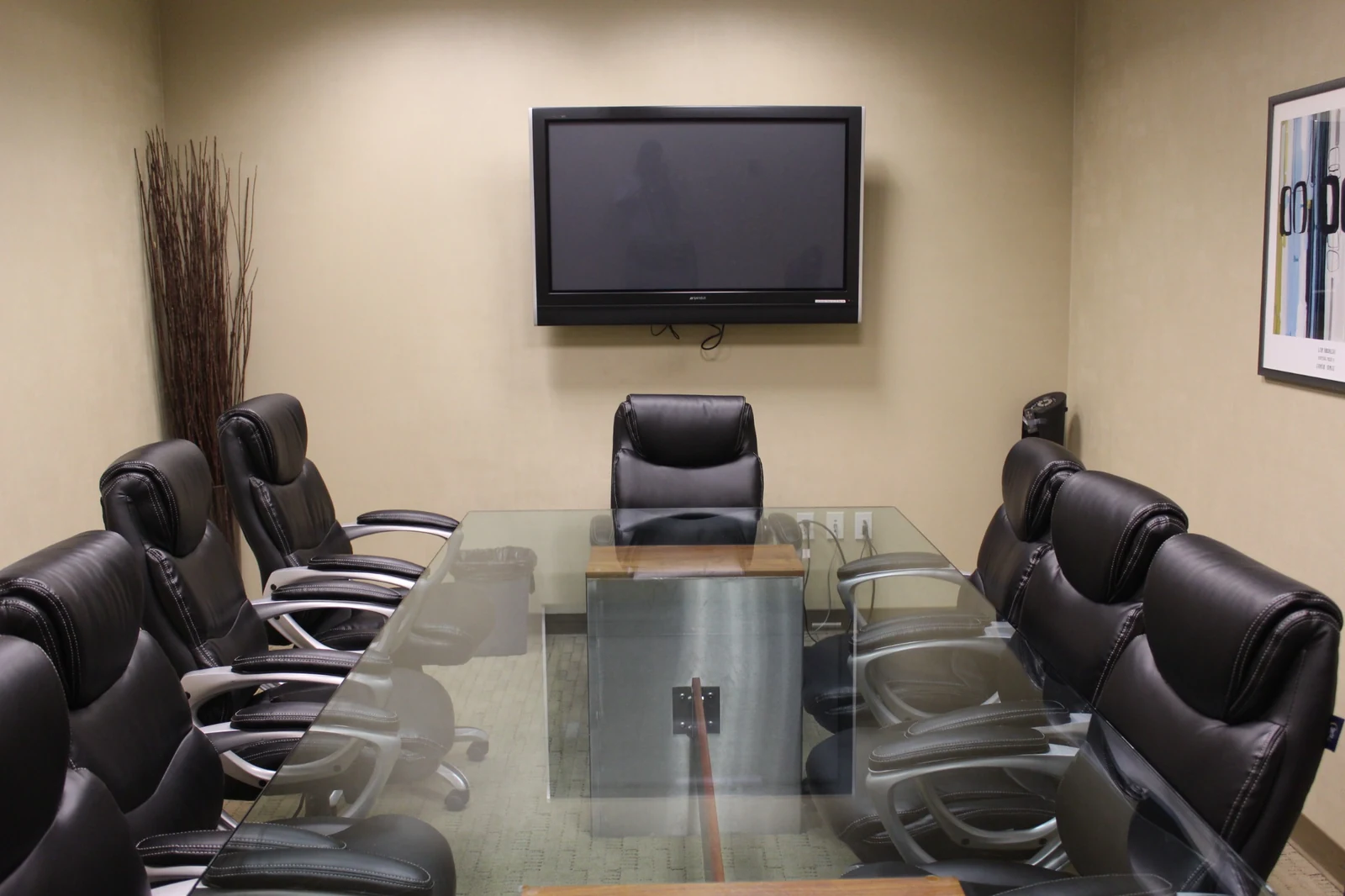 Conference table facing the wall-mounted presentation display at Gateway Executive Suites, 500 East E Street