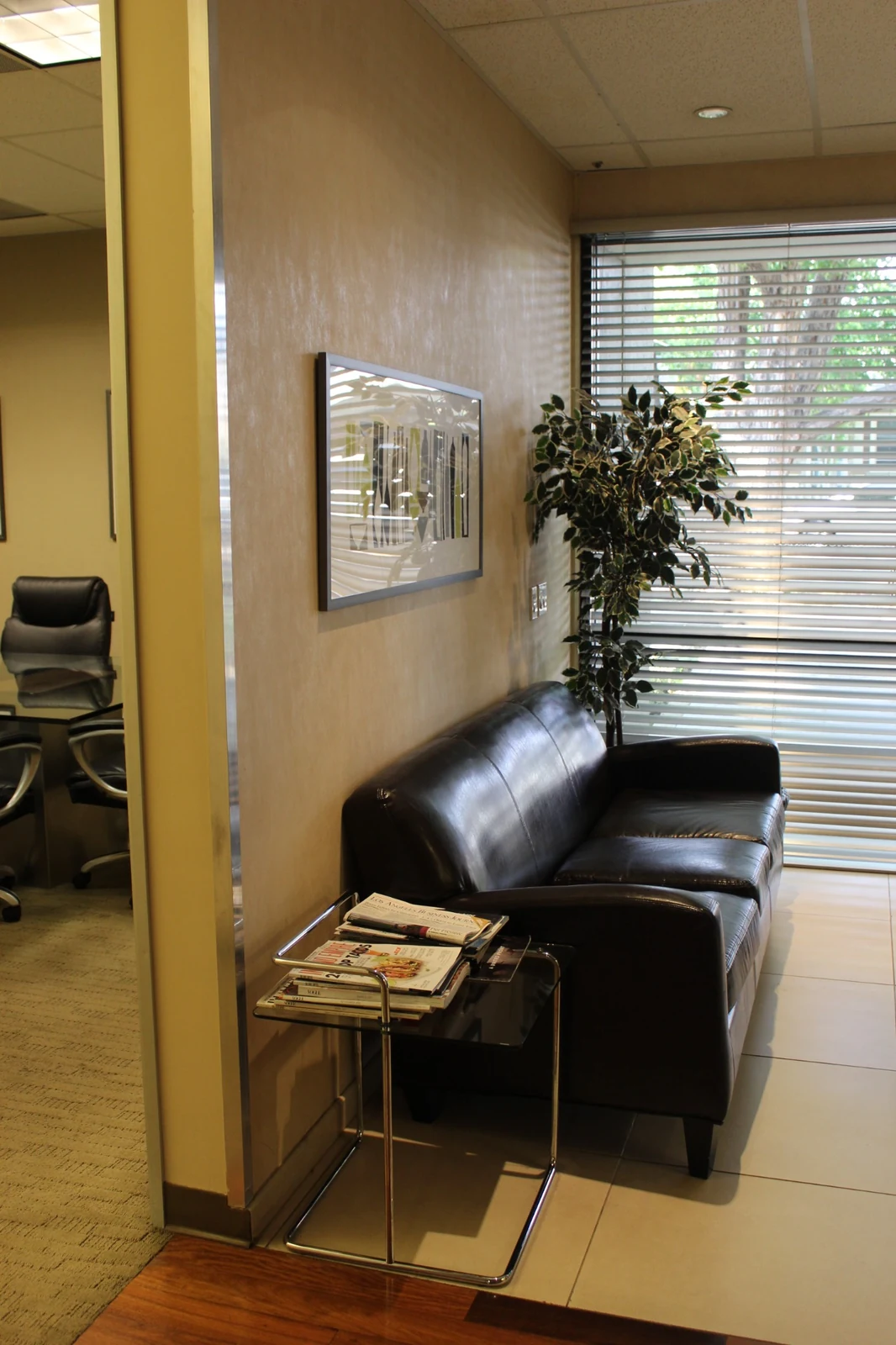 Waiting area at Gateway Executive Suites, 500 East E Street with a leather sofa, window blinds and a magazine table