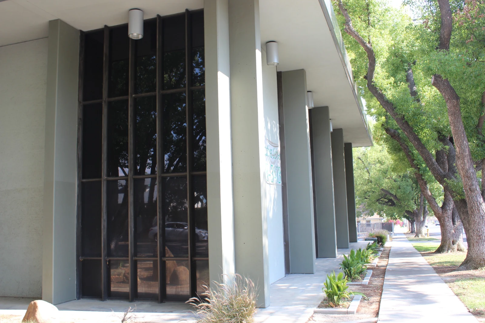 Gateway Executive Suites at 500 East E Street with tall windows beside the tree-lined sidewalk