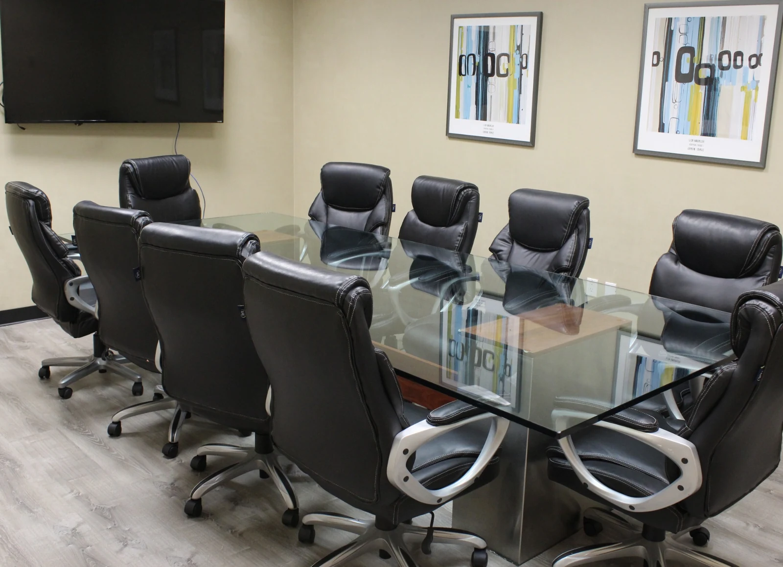 Gateway Executive Suites: conference room with glass table, padded chairs and wall display at 500 East E Street