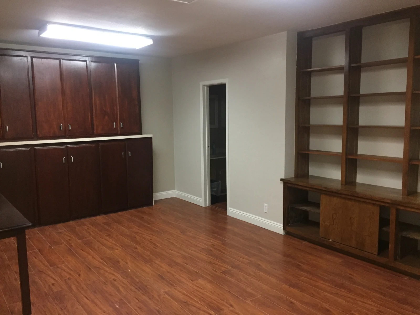 Office interior at Ontario Executive Suites, 525 N Laurel Avenue with wood cabinets and open shelving