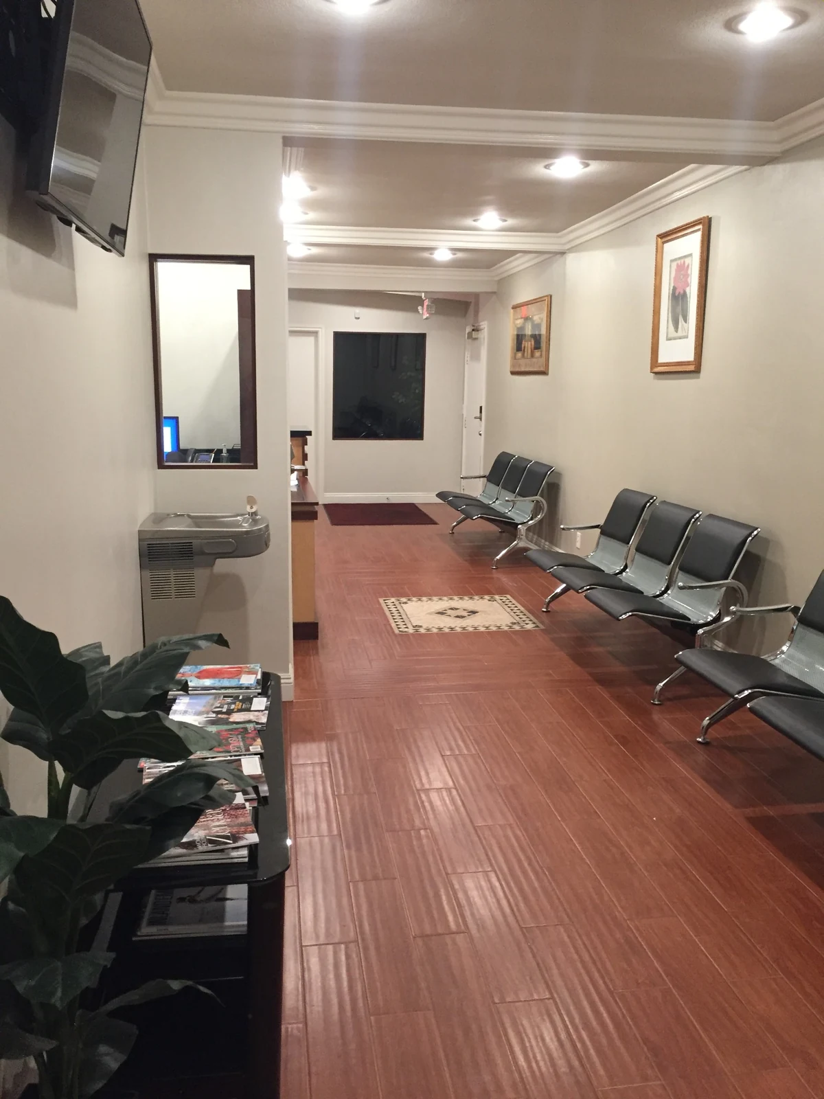Waiting area at Ontario Executive Suites, 525 N Laurel Avenue with seating, framed artwork and a potted plant