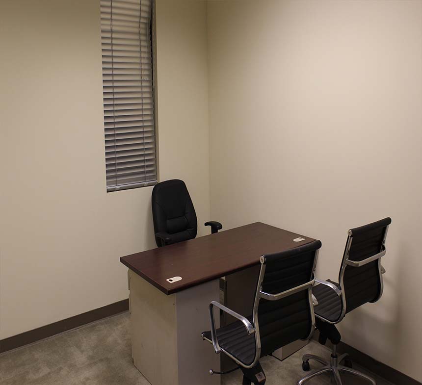 Furnished three-person Day Office with a desk and guest seating